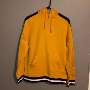 Mustard yellow, black, and white hoodie.
